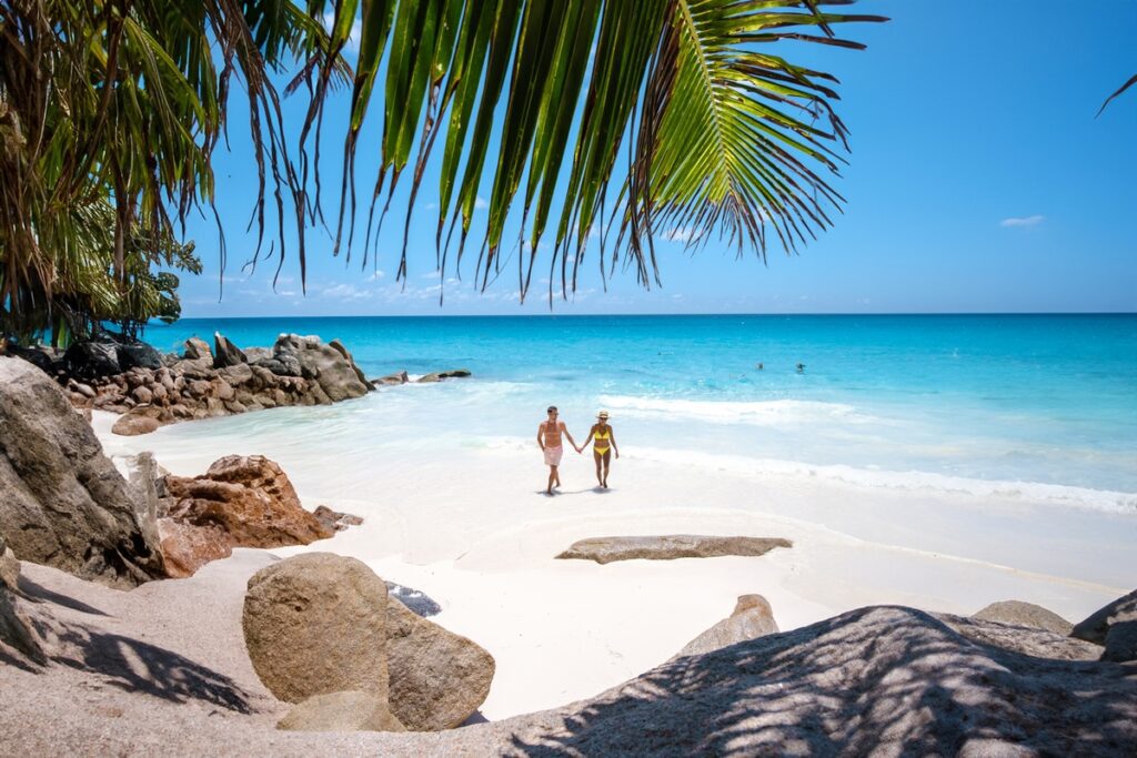 Anse Source d'Argent beach, La Digue Island, Seyshelles couple men and woman at the beach Anse Source d'Argent beach, La Digue Island, Seyshelles couple men and woman at the beach