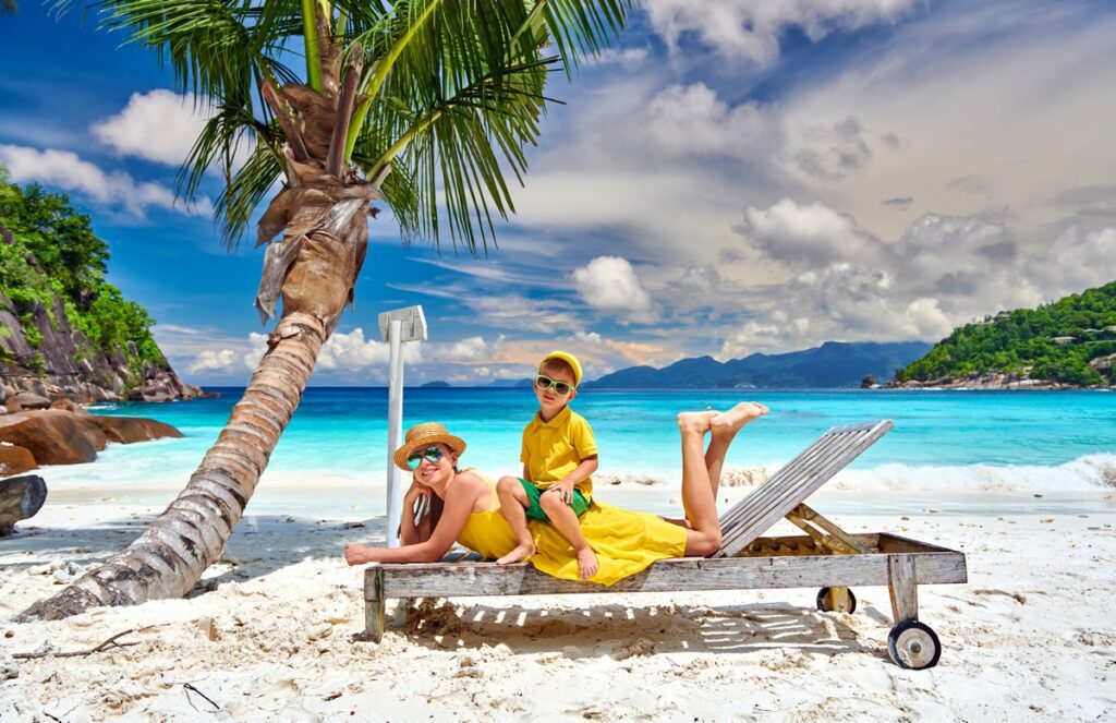 Family with three year old boy on beach. Seychelles, Mahe.